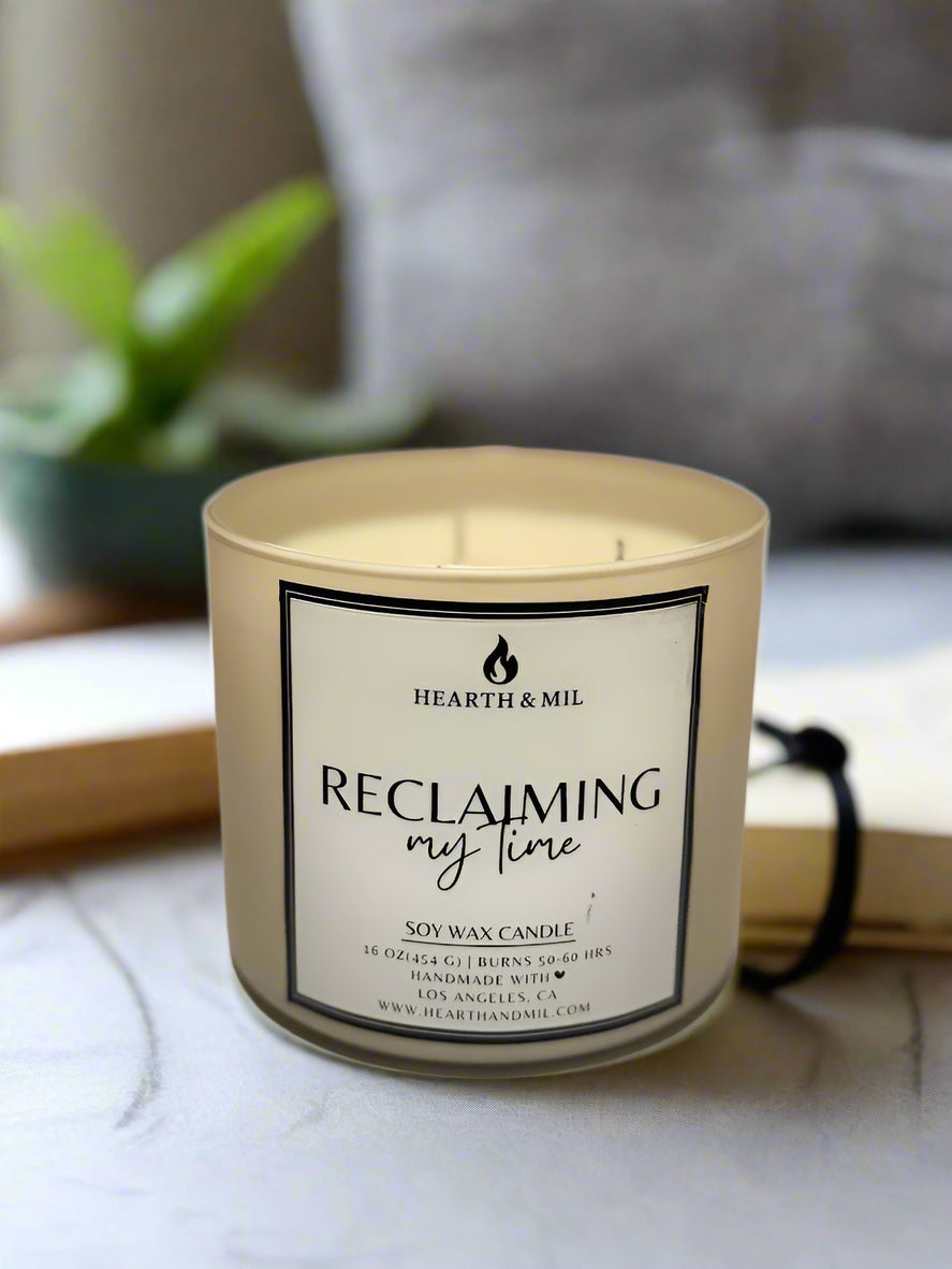 Candle with 'Hearth & Mil' label on a light surface